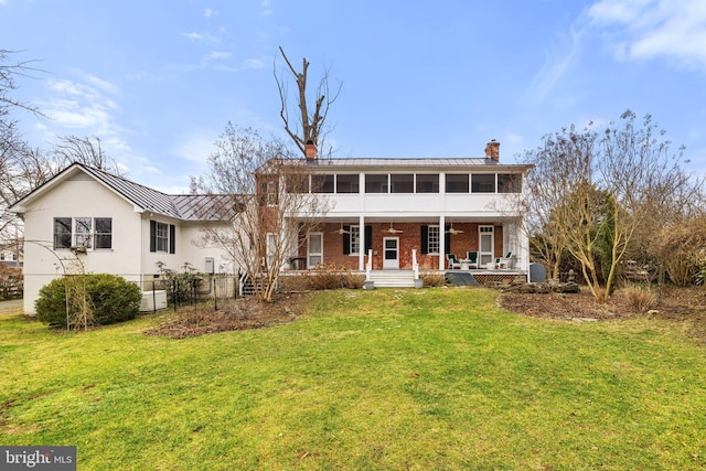 view of front of house with a porch, a sunroom, and a front lawn