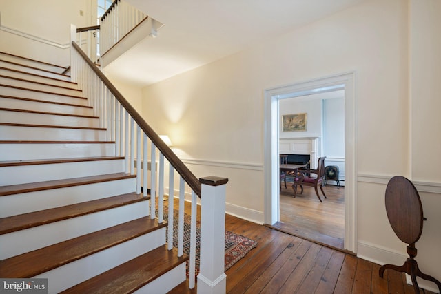 stairs with hardwood / wood-style floors