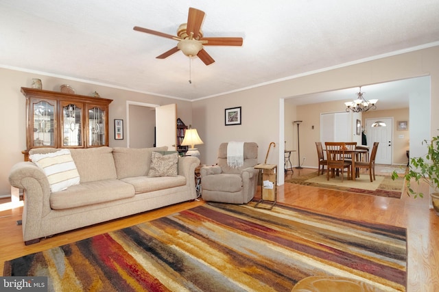 living room featuring crown molding, ceiling fan with notable chandelier, and hardwood / wood-style floors