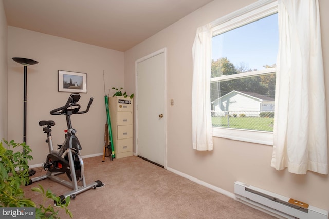 workout area with a baseboard radiator and light carpet