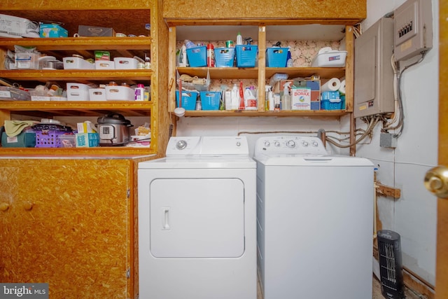 clothes washing area featuring washing machine and clothes dryer and electric panel