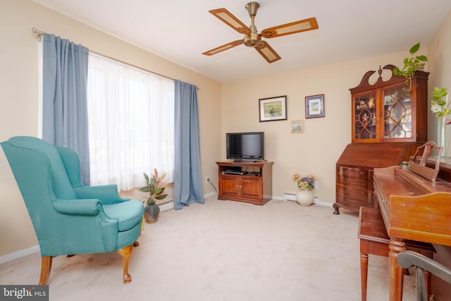 living area featuring ceiling fan and carpet