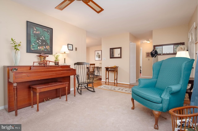 living area with carpet floors and ceiling fan