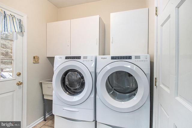 washroom featuring cabinets, light tile patterned floors, and independent washer and dryer