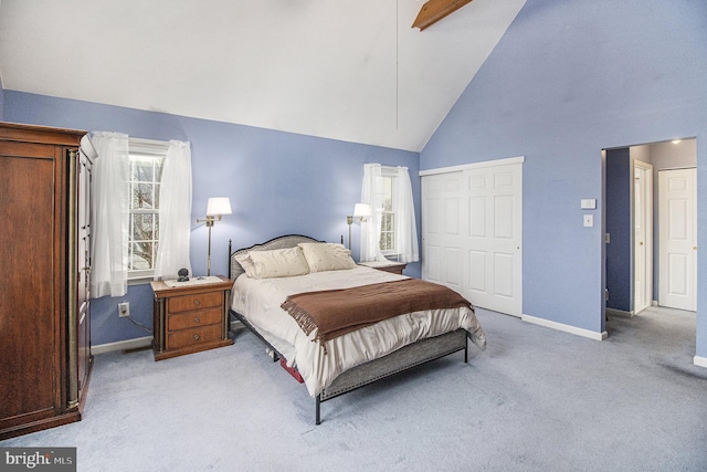 carpeted bedroom with beam ceiling, high vaulted ceiling, a closet, and ceiling fan