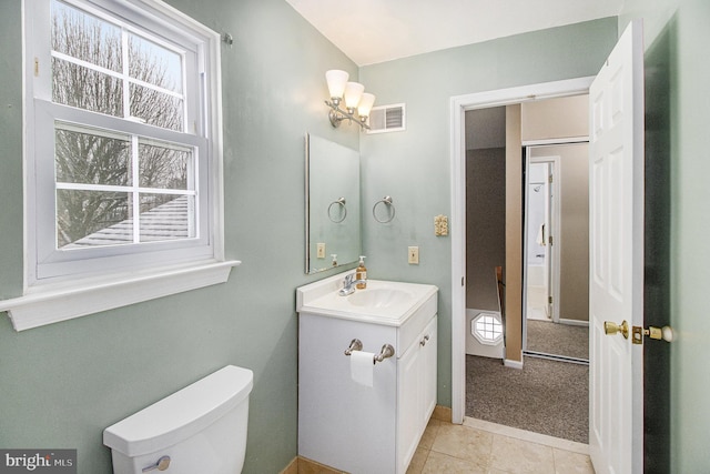 bathroom with tile patterned floors, vanity, and toilet