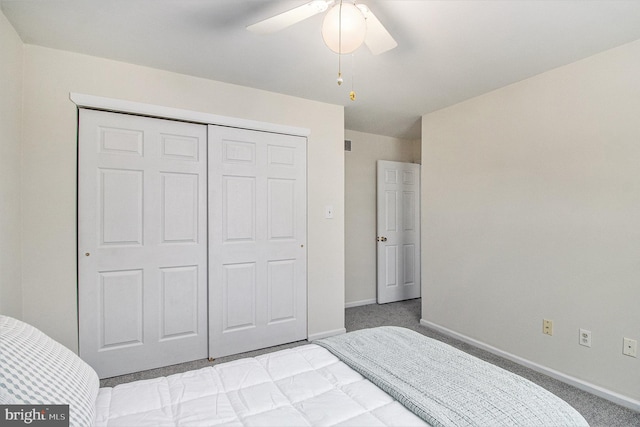 bedroom featuring ceiling fan, light colored carpet, and a closet