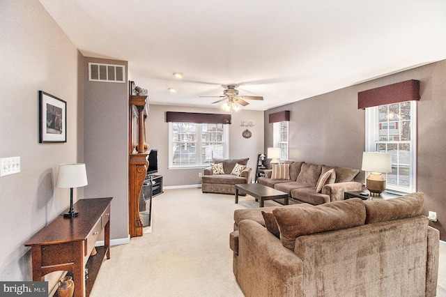 living room featuring light carpet and ceiling fan