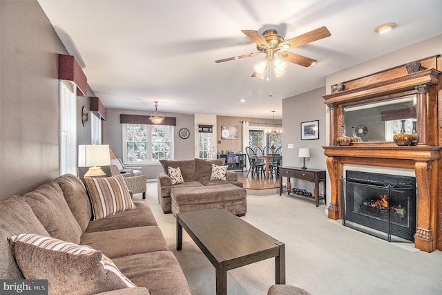 living room with light colored carpet and ceiling fan