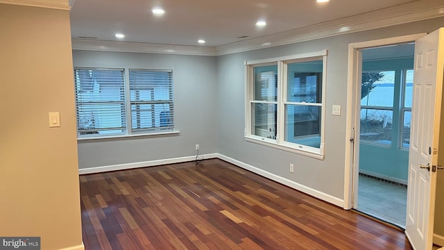 spare room featuring baseboards, ornamental molding, wood finished floors, and recessed lighting