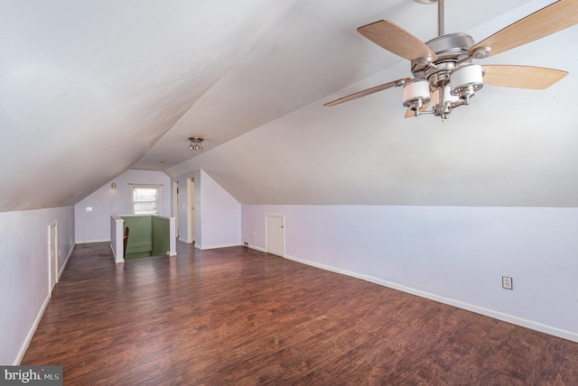 additional living space featuring vaulted ceiling, wood finished floors, a ceiling fan, and baseboards