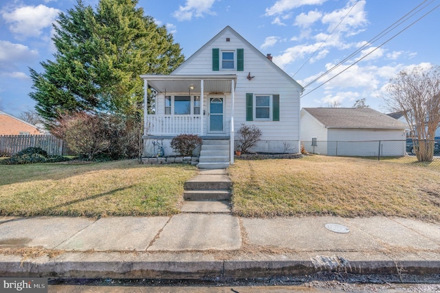 bungalow with a porch and a front yard