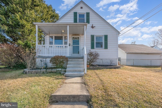 bungalow-style home with a front yard and covered porch