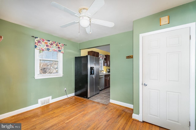 kitchen featuring wood-type flooring, ceiling fan, and appliances with stainless steel finishes