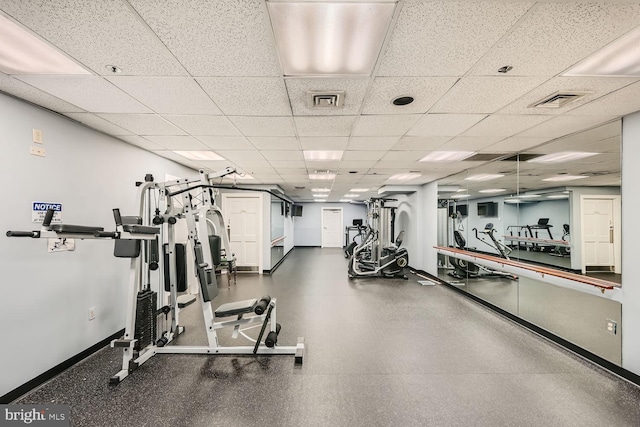 exercise room with a paneled ceiling