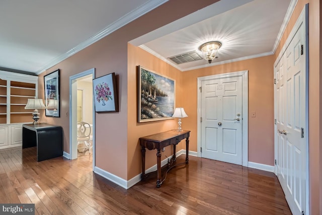 entryway with hardwood / wood-style flooring and ornamental molding