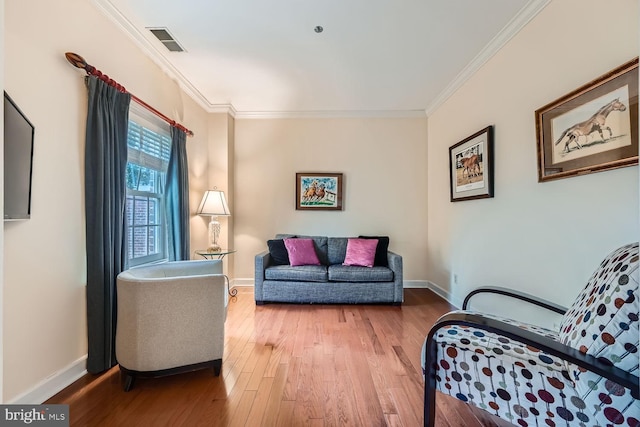 sitting room featuring hardwood / wood-style flooring and ornamental molding