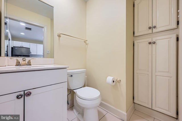 bathroom with vanity, tile patterned floors, and toilet