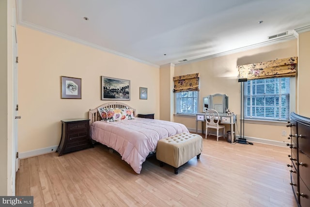 bedroom with ornamental molding and light hardwood / wood-style floors