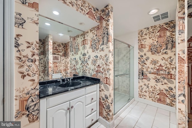 bathroom featuring an enclosed shower, vanity, and tile patterned flooring