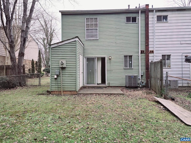 back of property with a yard, a patio area, and central air condition unit