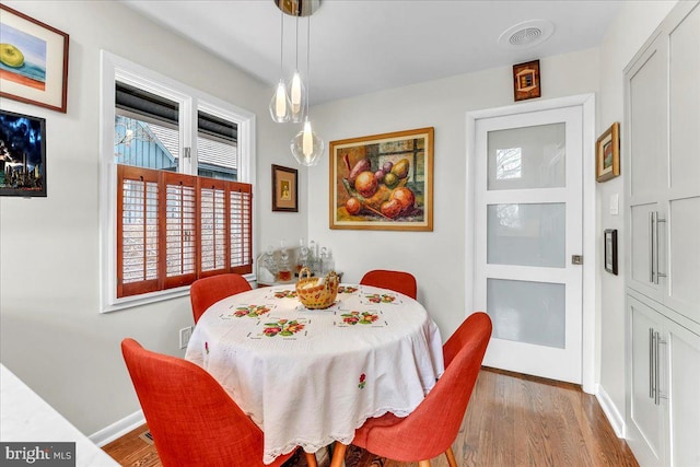 dining room with hardwood / wood-style flooring