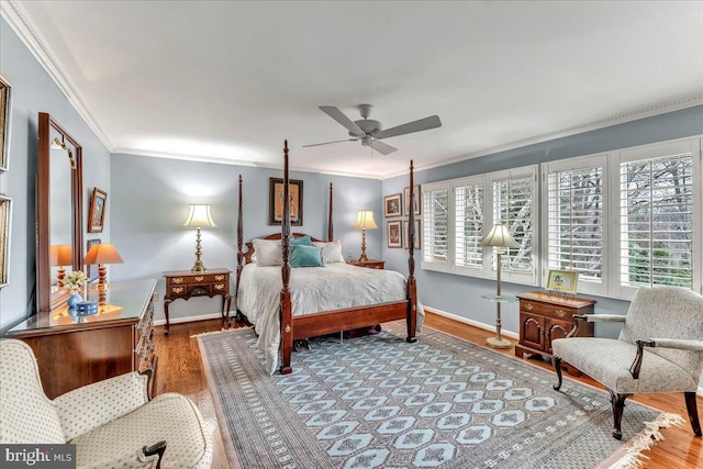 bedroom featuring ceiling fan, ornamental molding, and hardwood / wood-style floors