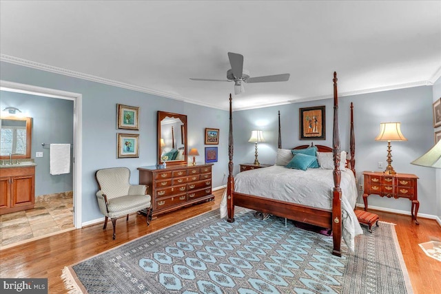 bedroom with crown molding, wood-type flooring, and sink