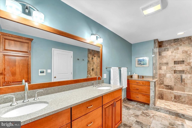 bathroom with vanity and a shower with door