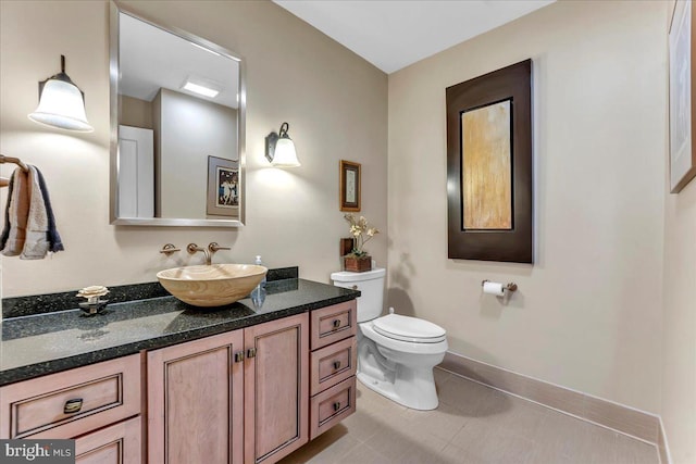 bathroom with vanity, tile patterned floors, and toilet