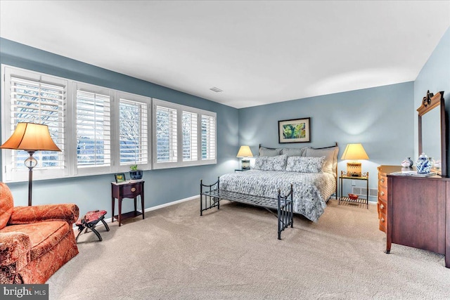 bedroom featuring light carpet