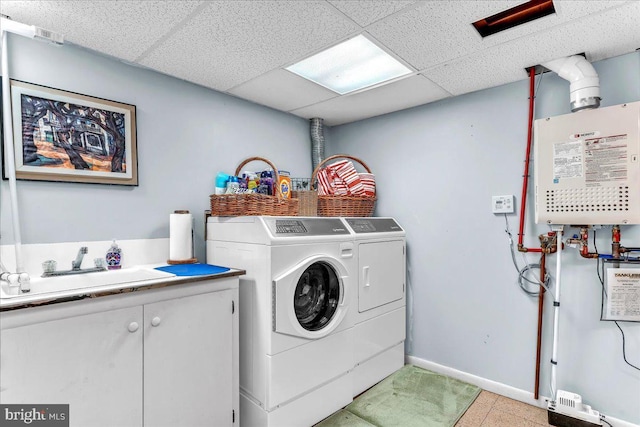 laundry room featuring cabinets, sink, and washing machine and clothes dryer