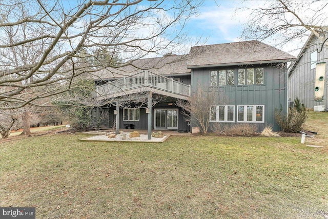 back of house with a patio, a wooden deck, and a lawn