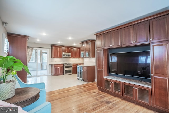 living room with wine cooler and light hardwood / wood-style flooring