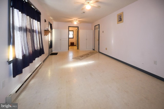 spare room with a baseboard radiator and ceiling fan