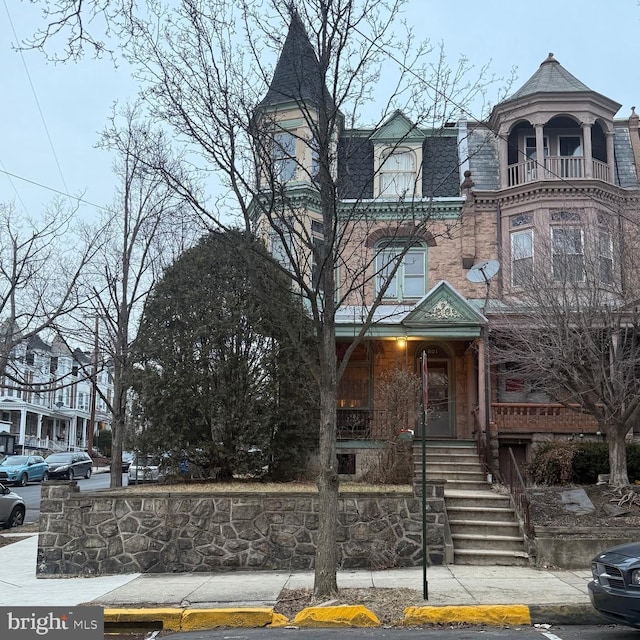 view of front of property featuring mansard roof