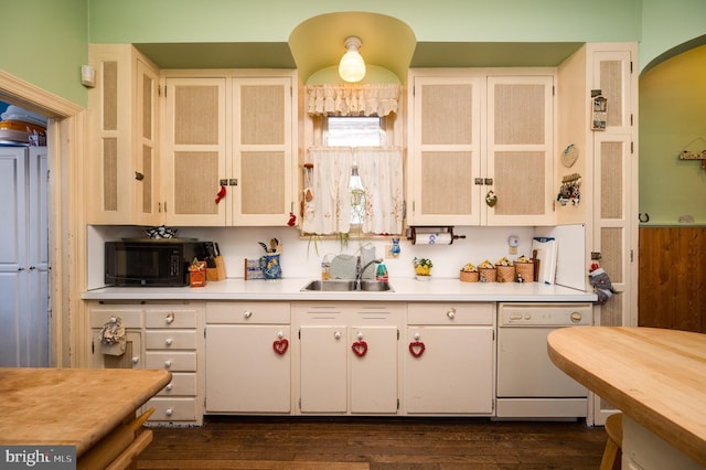 kitchen with dark wood-style flooring, black microwave, light countertops, and dishwasher