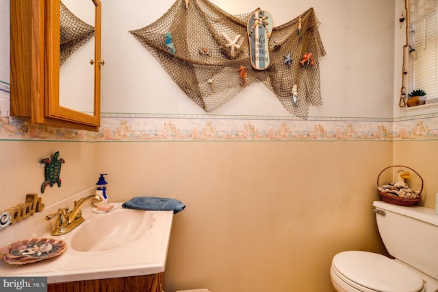 half bathroom featuring toilet and vanity