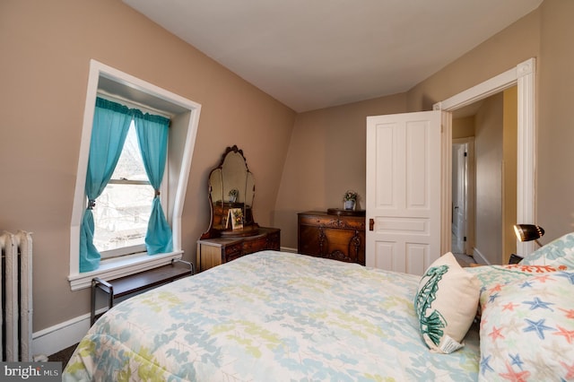 bedroom with radiator heating unit and baseboards