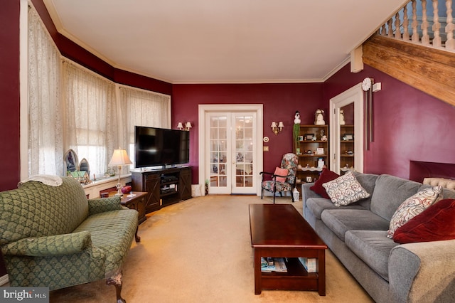 living area with ornamental molding, french doors, and light carpet