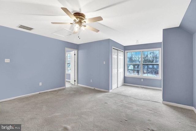 spare room with light carpet, lofted ceiling, and ceiling fan