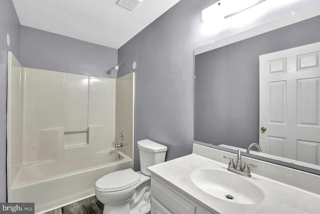 full bathroom featuring vanity, hardwood / wood-style flooring, shower / bathtub combination, and toilet