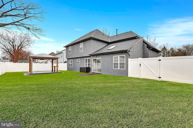 rear view of house featuring a yard, a gazebo, and central AC unit