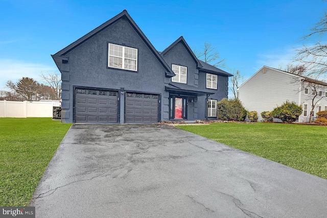 view of property featuring a garage and a front lawn