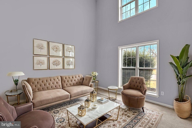 living room featuring light carpet and a high ceiling