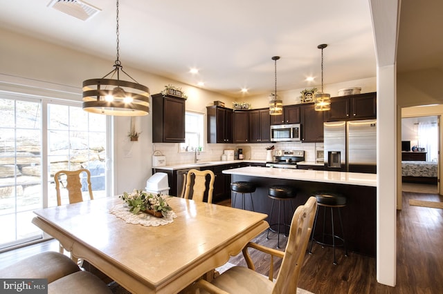 dining area with dark hardwood / wood-style floors and sink