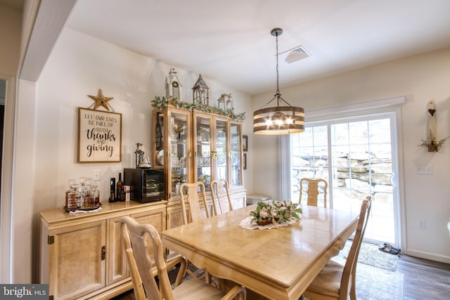 dining room with wood-type flooring and a chandelier