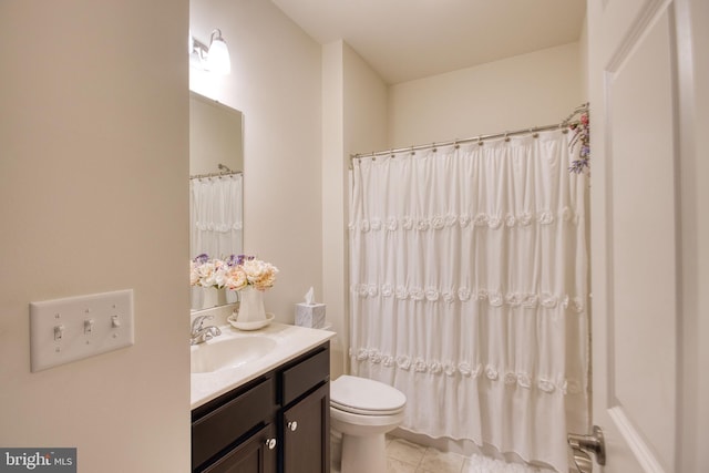 bathroom featuring vanity, tile patterned flooring, and toilet