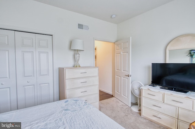 carpeted bedroom featuring a closet