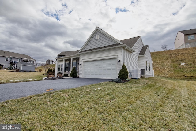 view of front of house featuring a garage and a front lawn